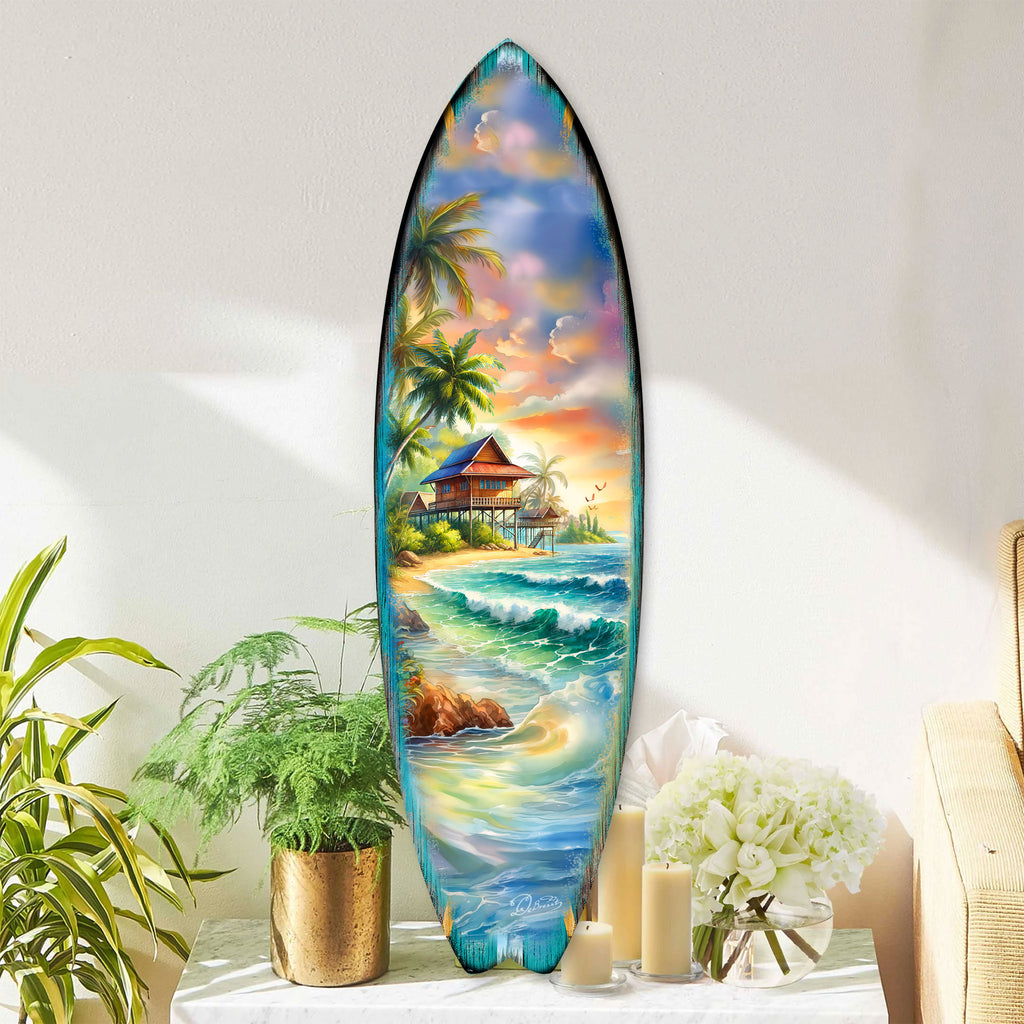 Handcrafted Tropical Beach House Surfboard Wall Art by G. DeBrekht, featuring a vibrant oceanfront bungalow, palm trees, and rolling waves. Perfect coastal wall decor for beach house interiors, surf-inspired spaces, and nautical-themed rooms. UV-coated for indoor & outdoor display.