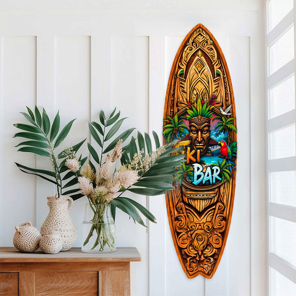 Handcrafted Tiki Bar Surfboard Wall Art by G. DeBrekht, featuring a bold tiki mask, palm trees, tropical sunset, and vibrant parrot. Perfect coastal wall decor for tiki bars, beach house interiors, and island-themed spaces. UV-coated for indoor & outdoor display.