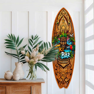 Handcrafted Tiki Bar Surfboard Wall Art by G. DeBrekht, featuring a bold tiki mask, palm trees, tropical sunset, and vibrant parrot. Perfect coastal wall decor for tiki bars, beach house interiors, and island-themed spaces. UV-coated for indoor & outdoor display.