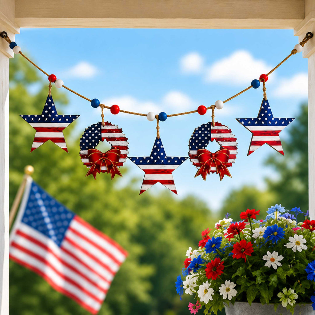 A patriotic display featuring American flags and star-shaped ornaments, with a potted plant of colorful flowers in the foreground.