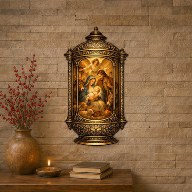 a religious nativity scene with a golden frame, hanging on a brick wall. Next to the nativity scene is a vase with red berries, and a lit candle on a wooden surface.