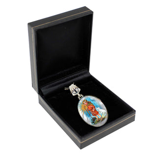 A pendant with a religious or symbolic design is displayed in a black jewelry box.