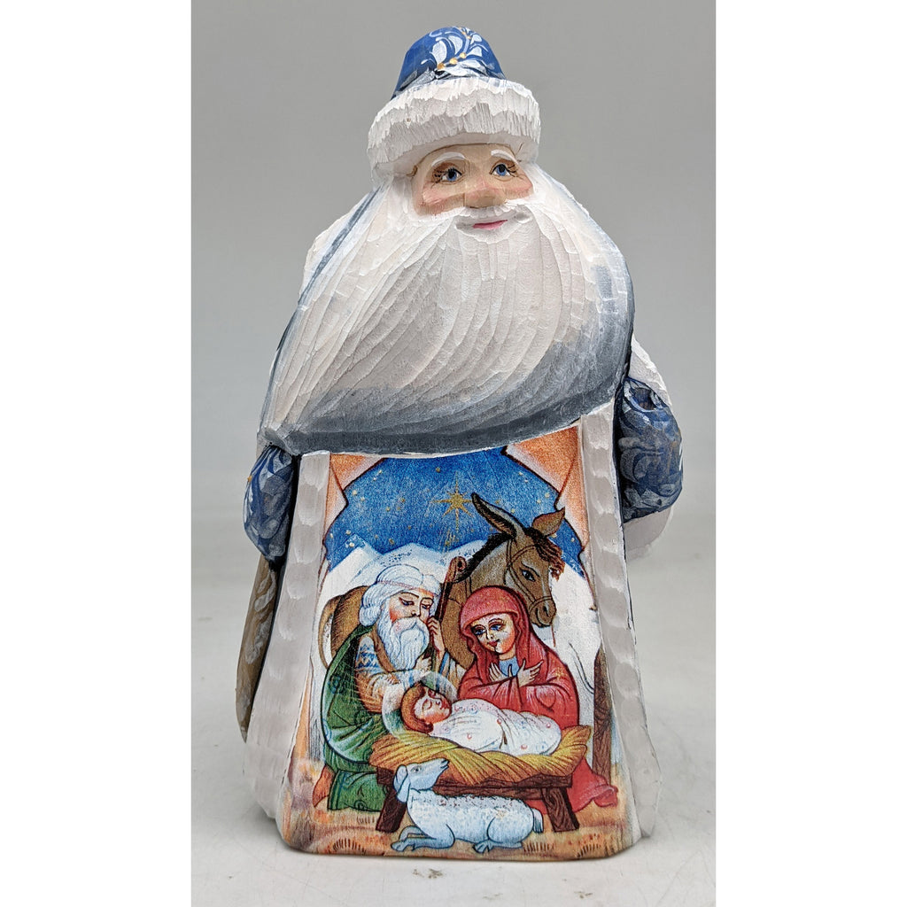 A carved wooden Santa Claus figure with a nativity scene depicted on its back.