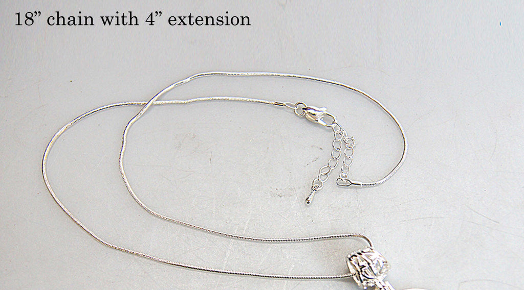 A silver 18-inch chain with a 4-inch extension necklace is shown on a white surface.