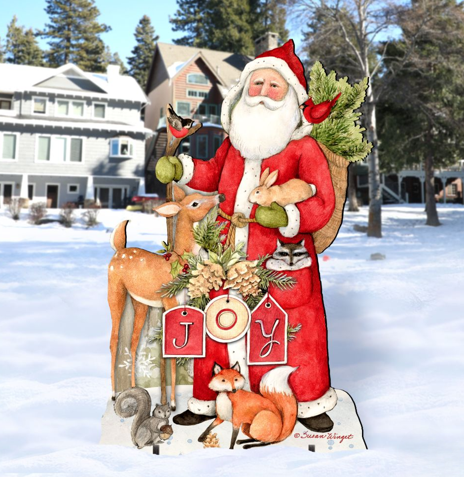 A cardboard cutout of Santa Claus holding a bag of presents and surrounded by animals, including a deer, squirrel, and fox, in a snowy outdoor setting.