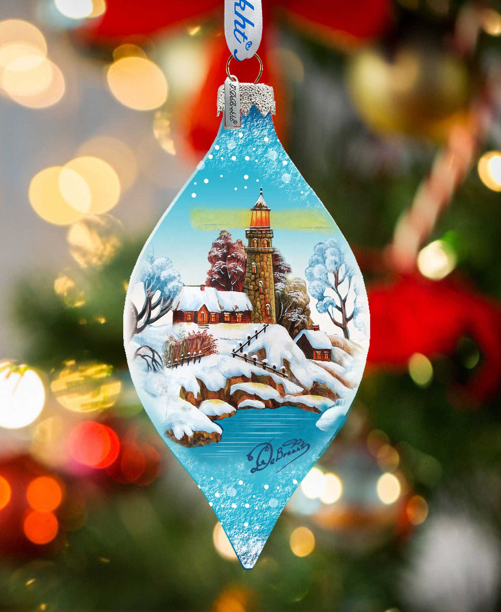 a glass ornament hanging from a christmas tree