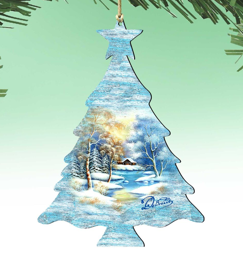 A Christmas tree ornament with a winter landscape scene, featuring snow-covered trees, a frozen lake, and a cabin in the distance.