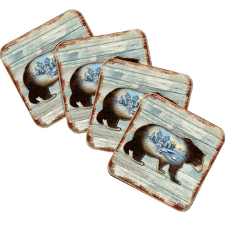 A set of four square coasters featuring a bear silhouette against a winter landscape.