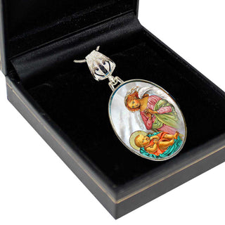 A silver pendant with an oval-shaped design, featuring a depiction of a baby and an angel, is displayed in a black jewelry box.