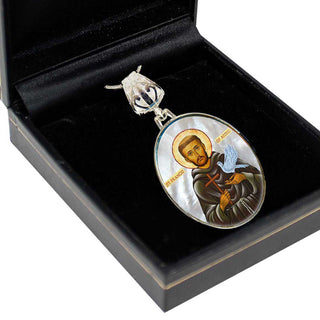 A pendant with a religious icon, possibly a saint or religious figure, is displayed in a black box.