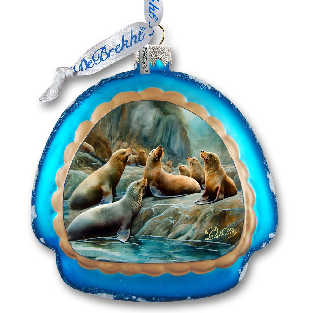 a glass ornament with a picture of sea lions
