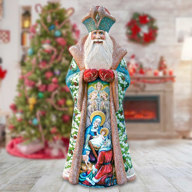 A colorful and detailed statue of a saint or religious figure, adorned with intricate patterns and designs, stands in a room decorated for Christmas.