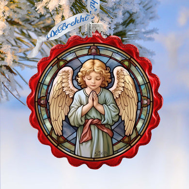 a stained glass angel ornament hanging from a christmas tree