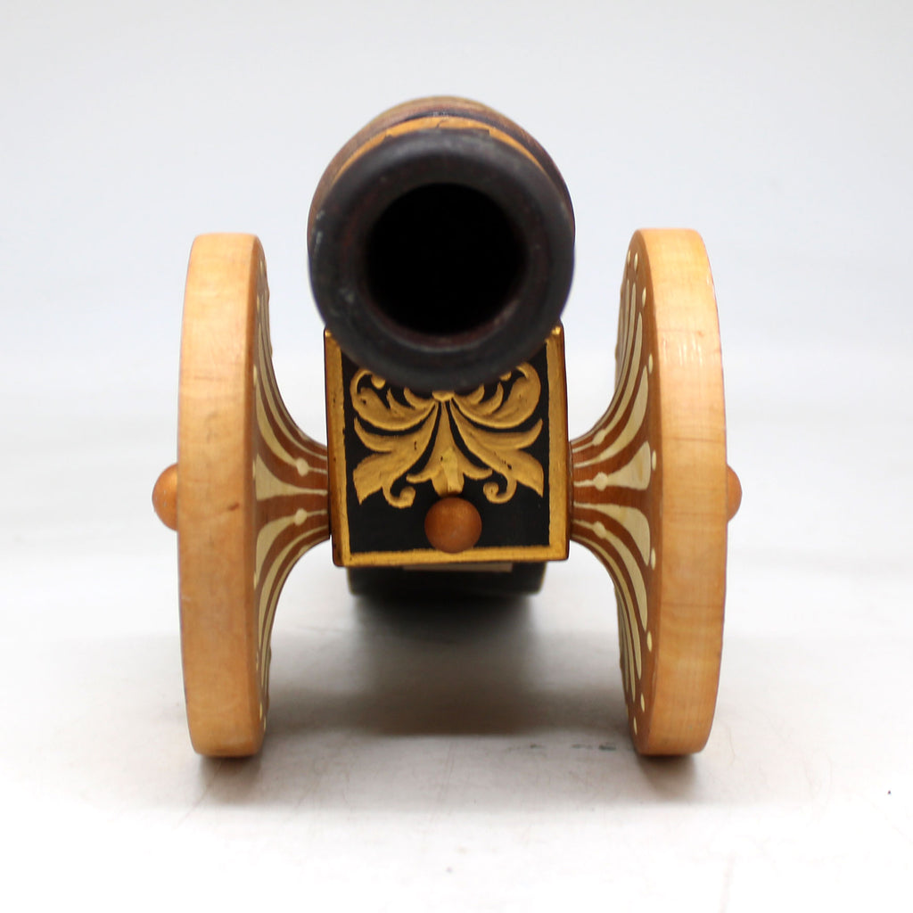 a small wooden toy car with a black top