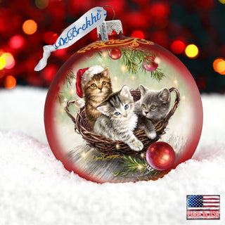 a christmas ornament with two kittens in a basket