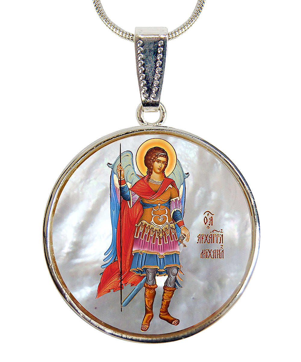 a round pendant with a depiction of a saint or religious figure, possibly a saint or religious icon, wearing a red robe and holding a staff or weapon.