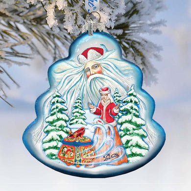A blue ornament with a painted Santa Claus figure and a sled, surrounded by snow-covered pine trees.