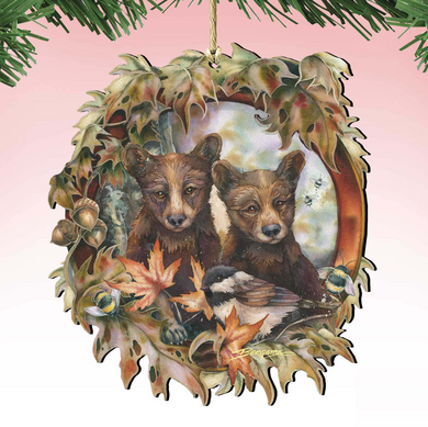A wooden ornament featuring two brown bears surrounded by autumn leaves, flowers, and a bird.