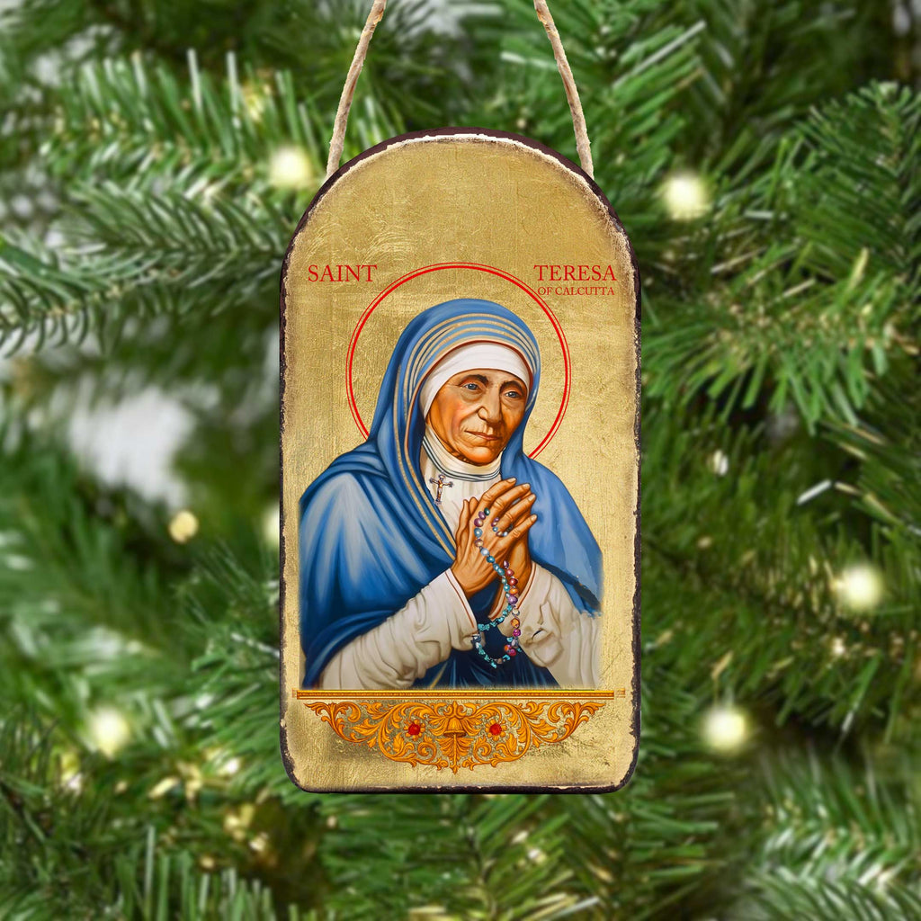 a religious icon of Saint Teresa of Calcutta, a prominent Catholic saint, hanging on a Christmas tree.