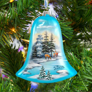 a bell ornament hanging from a christmas tree