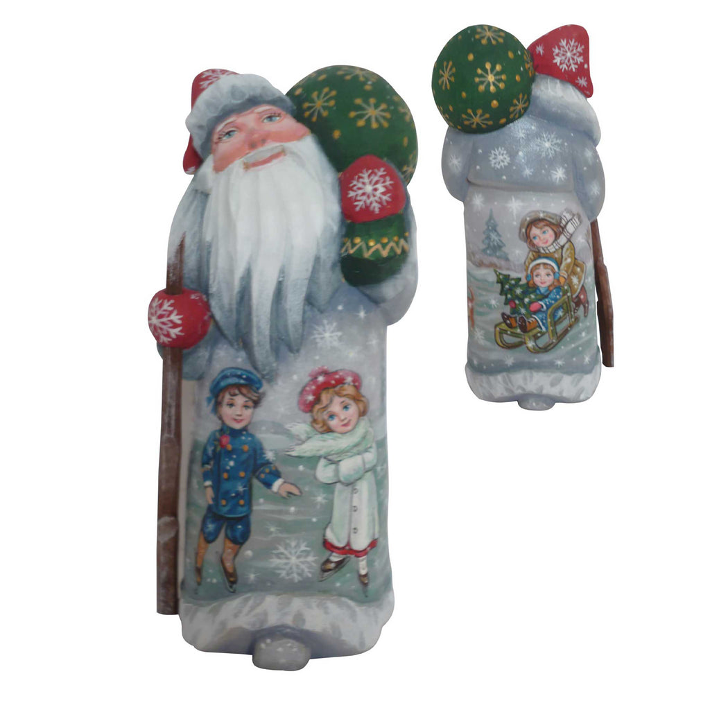 two Christmas-themed figurines, one depicting Santa Claus and the other featuring children.