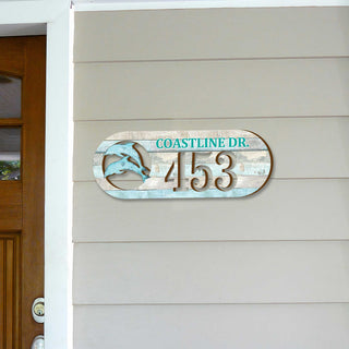Oval coastal address plaque featuring dolphin cutout, house number 453, and customizable COASTLINE DR. street name, handcrafted by GDebrekht Artistic Studio. Perfect for nautical house numbers, coastal door decoration, beach house decor, and outdoor holiday decorations.