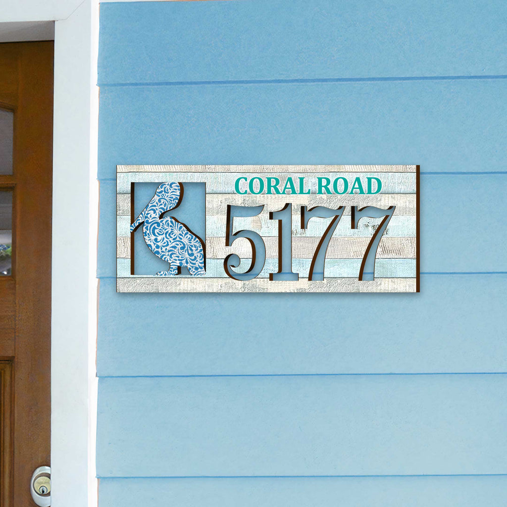 Coastal address plaque with blue pelican cutout, house number 5177, and customizable CORAL ROAD street name, handcrafted by GDebrekht Artistic Studio. Perfect for nautical house numbers, coastal door decoration, beach house decor, and outdoor holiday decorations.