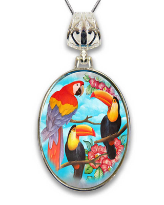 A pendant featuring a vibrant painting of three colorful parrots perched on branches with flowers.