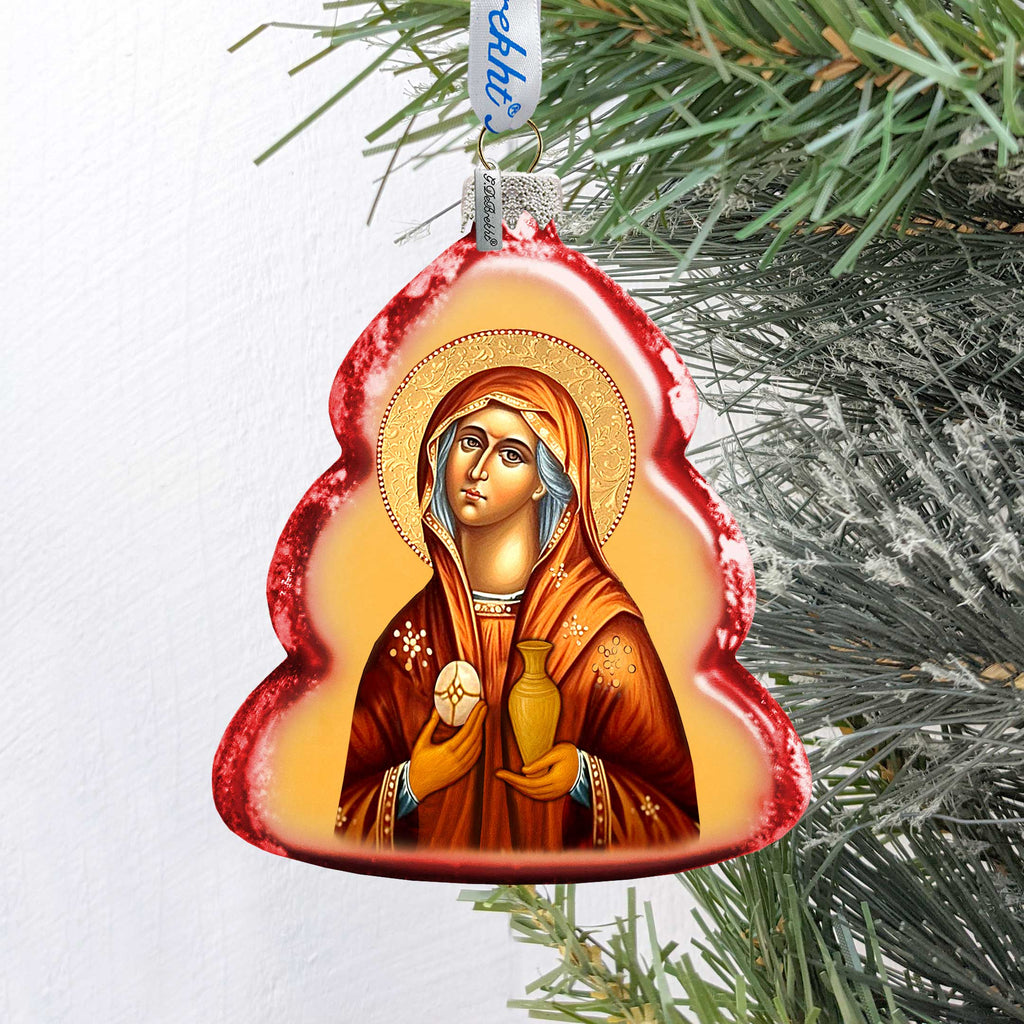 A Christmas ornament featuring a religious icon of a woman, possibly a saint or goddess, with a halo and holding a vase.