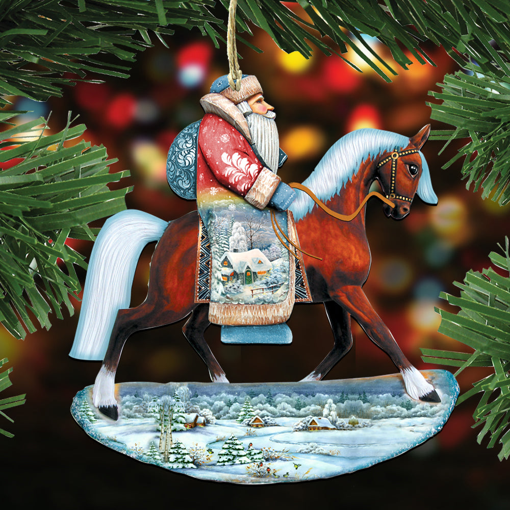 A Christmas ornament depicting Santa Claus riding a horse, with a snowy landscape in the background.