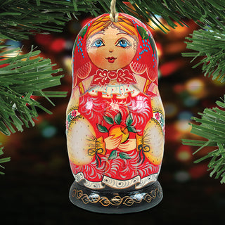 A colorful, intricately painted wooden doll ornament is displayed against a blurred background, possibly a Christmas tree.