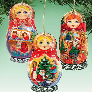 three colorful Christmas ornaments hanging from a tree branch.