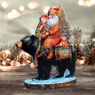a statue of santa claus riding a black bear