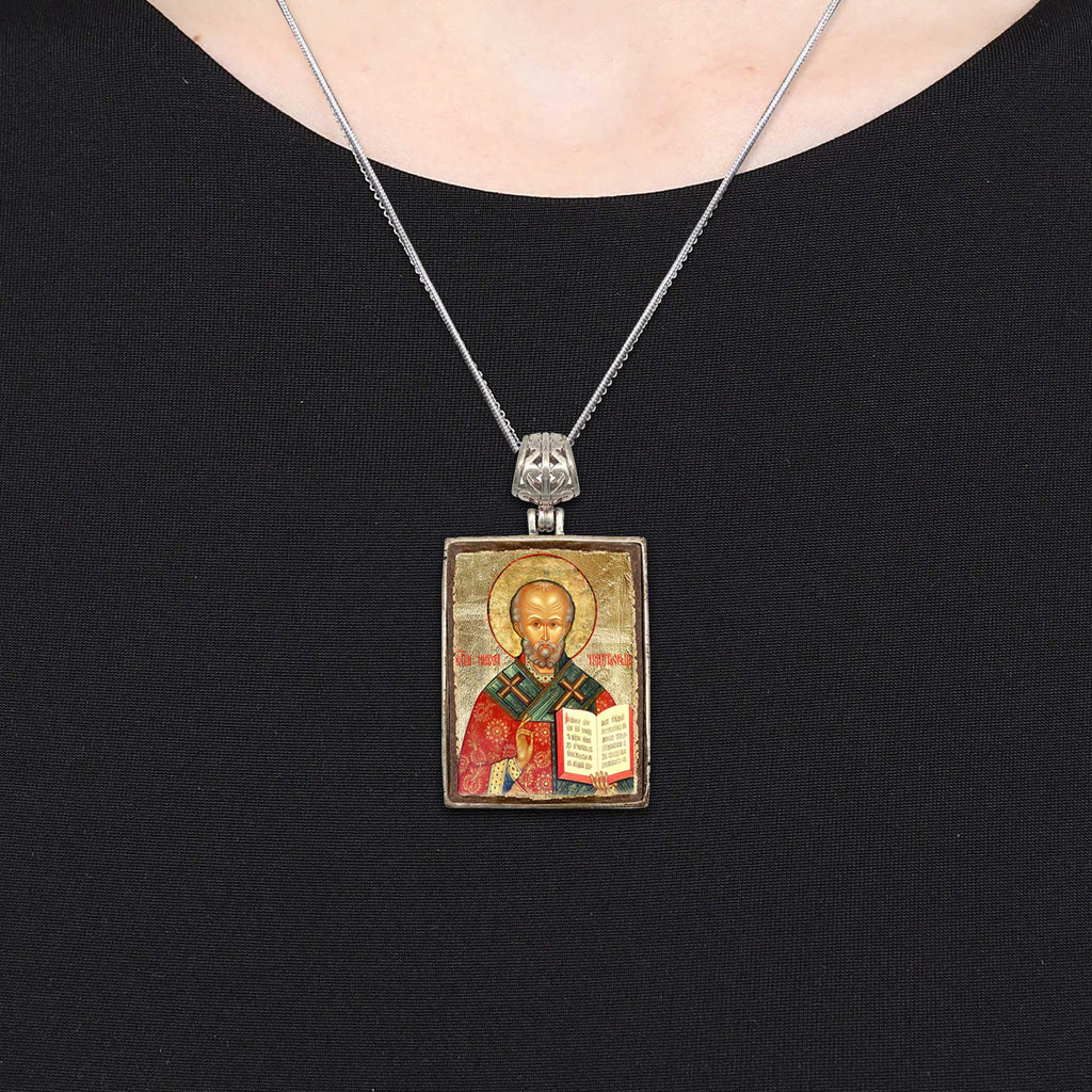 A necklace with a religious icon pendant, which appears to be a religious symbol or figure.