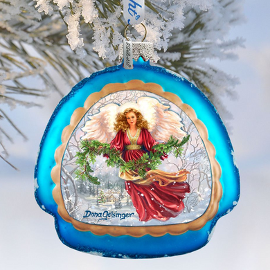 A blue ornament with a picture of an angel holding a wreath and surrounded by snow.