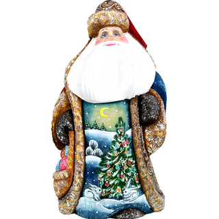 A colorful and detailed Christmas-themed sculpture depicting Santa Claus with a snowy landscape, a full moon, and a decorated Christmas tree.
