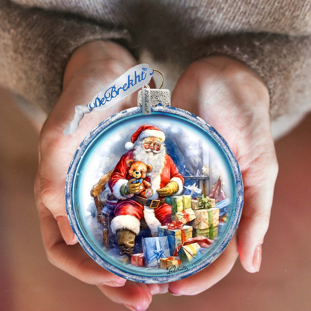 a person holding a christmas ornament in their hands