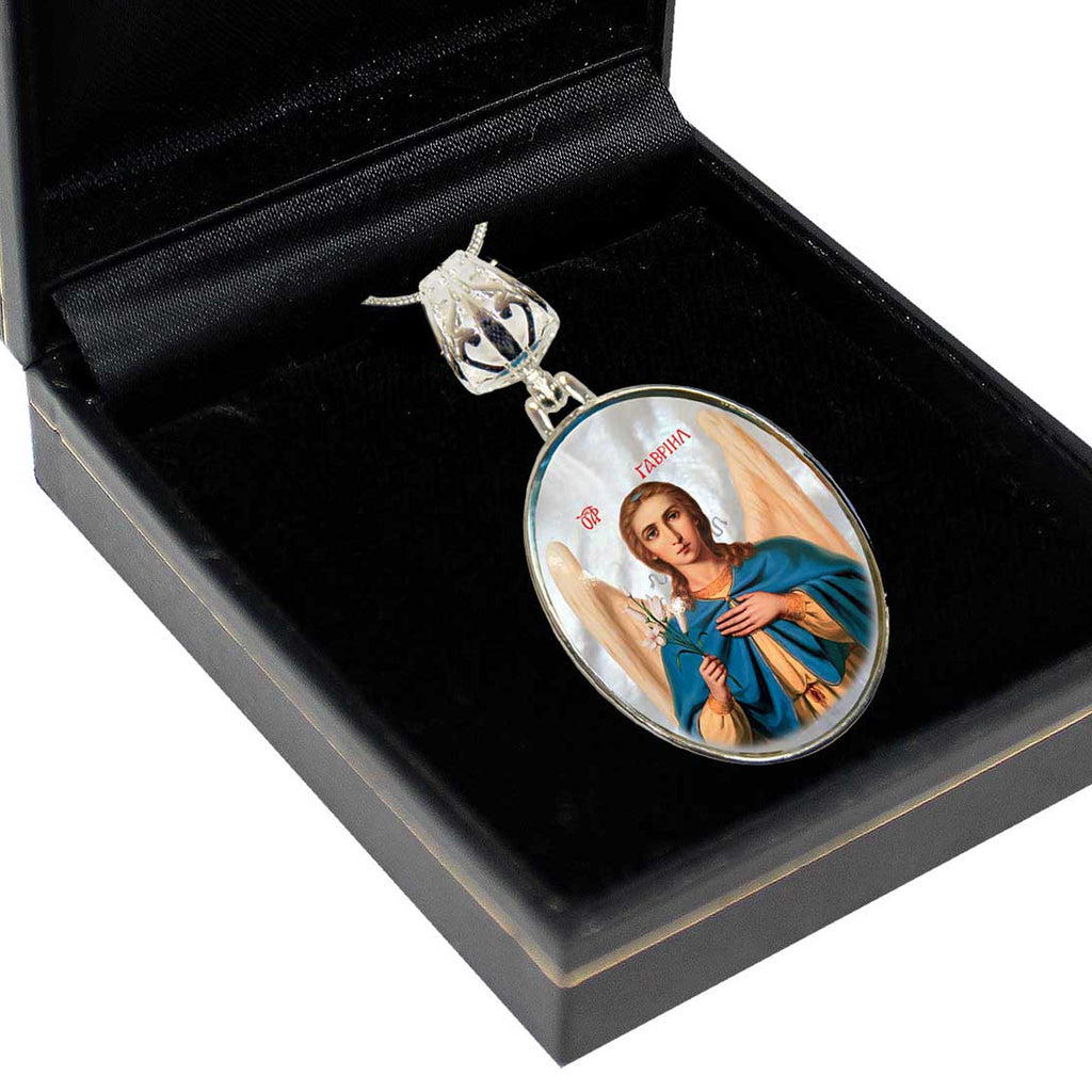a pendant with a religious symbol, such as a saint or angel, displayed in a black box.