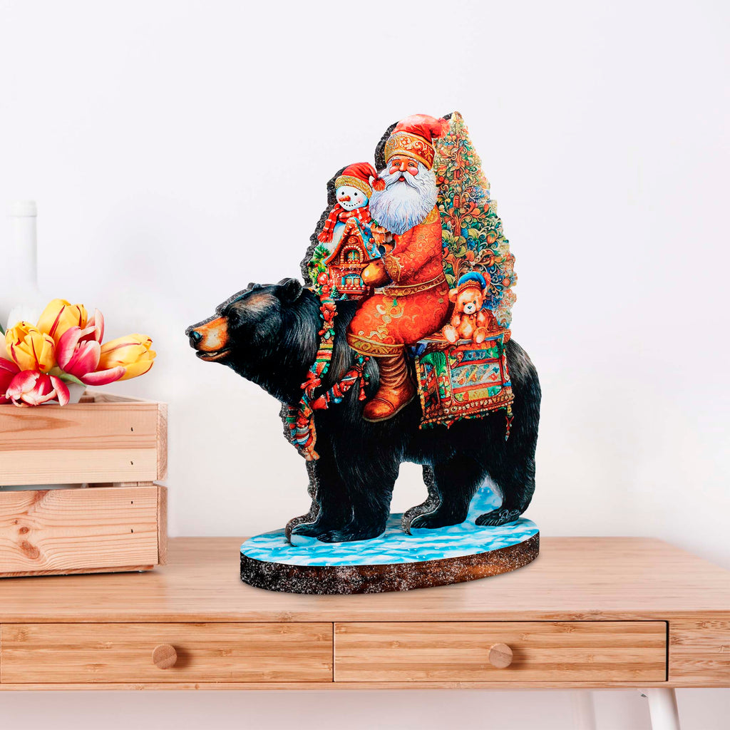 a statue of santa riding a bear on a table