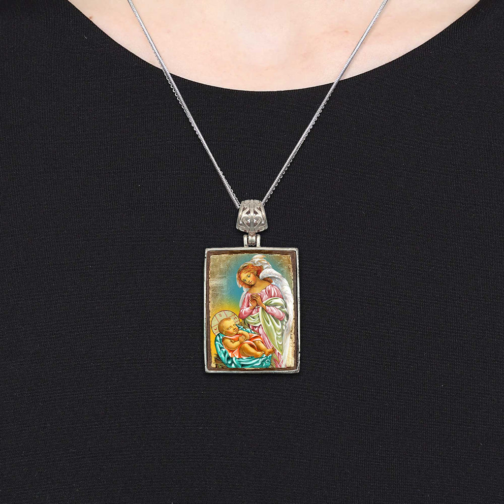 A silver pendant necklace with a rectangular pendant featuring an image of a religious figure, such as a saint or angel.