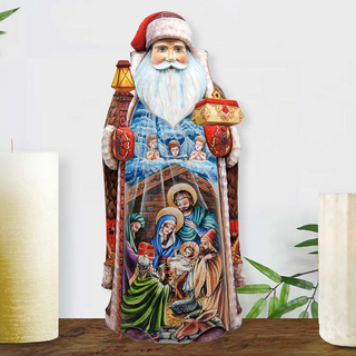 A colorful, hand-painted wooden Santa Claus figurine with a nativity scene depicted on its body.