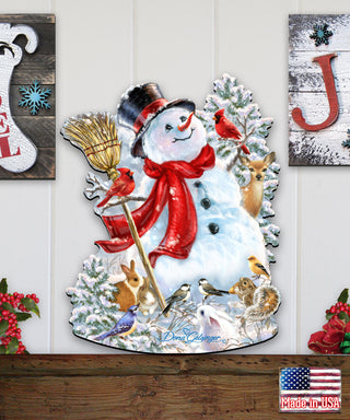 A snowman decoration with various animals, including a bird, a rabbit, and a squirrel, surrounding it. The snowman is wearing a red scarf and a top hat.