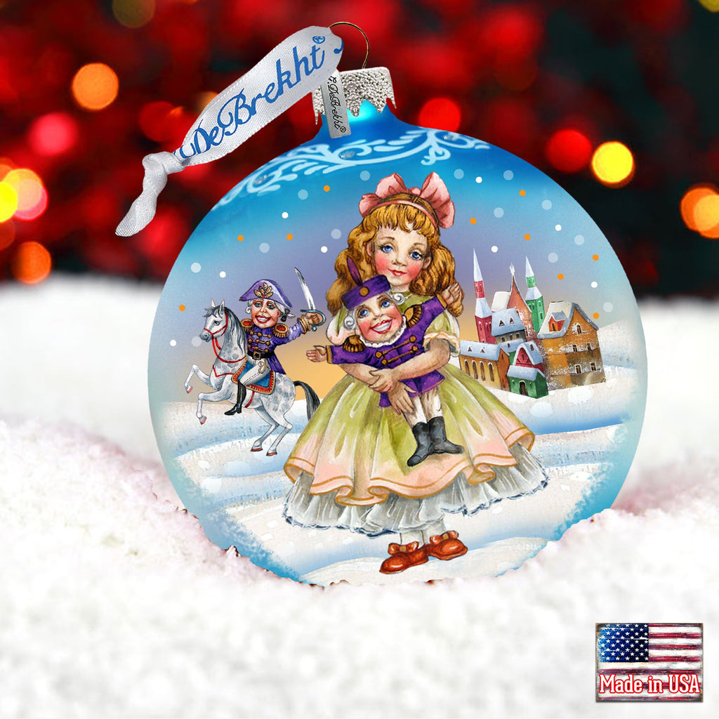 a glass ornament with a picture of a girl holding a baby