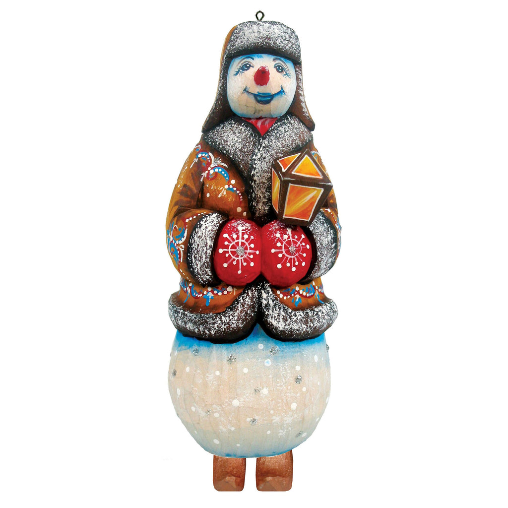 A colorful snowman ornament with a red nose, wearing a brown coat and holding a red and yellow lantern.