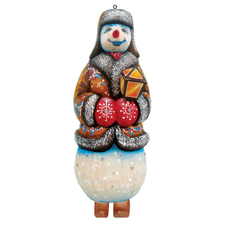 A colorful snowman ornament with a red nose, wearing a brown coat and holding a red and yellow lantern.