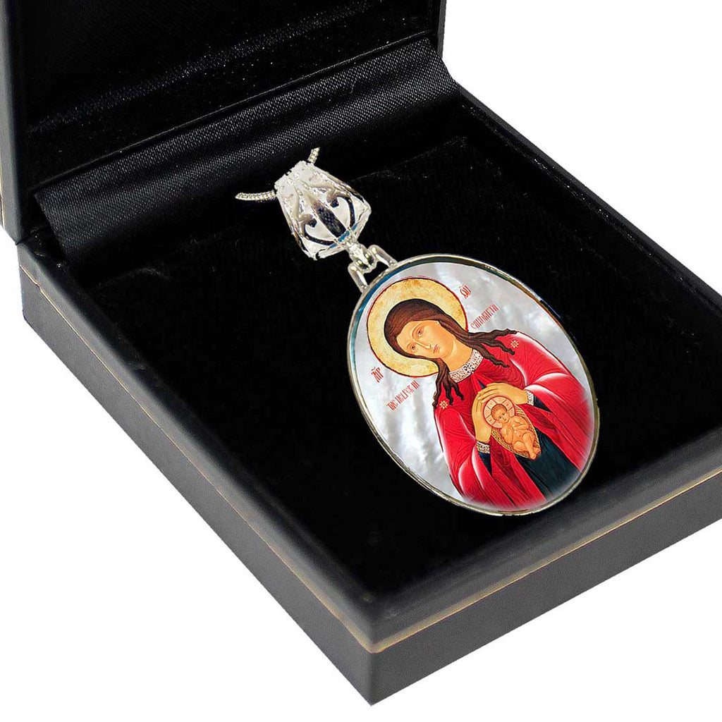 a pendant with a religious icon, placed inside a black box.