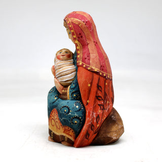 a ceramic figurine of a woman holding a baby