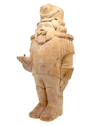 A wooden sculpture of a nutcracker figure, with intricate details and a detailed design.