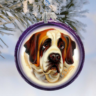 A purple ornament with a painting of a dog's face hanging from a branch of a snow-covered tree.