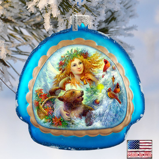 A blue ornament with a painted scene of a woman with a bear, surrounded by flowers and birds, hanging on a tree branch.